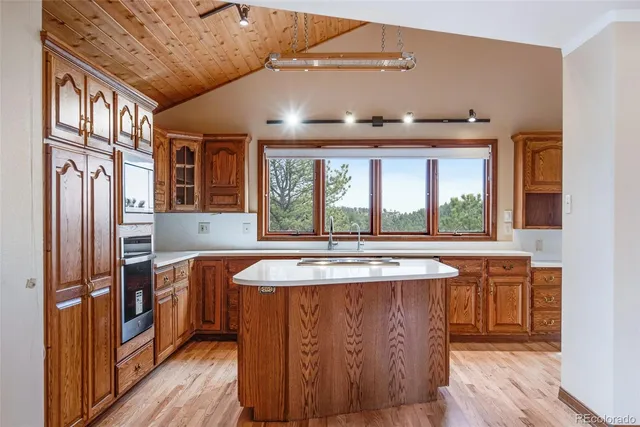 a kitchen with stainless steel appliances granite countertop a sink and a refrigerator