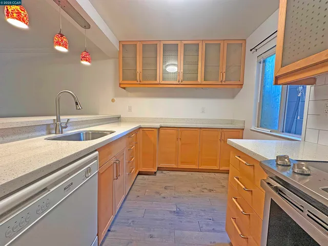 a kitchen with a sink stove and cabinets