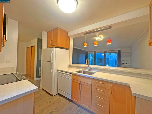 a kitchen with a sink cabinets and refrigerator