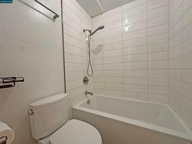 a white bath tub sitting next to a white toilet