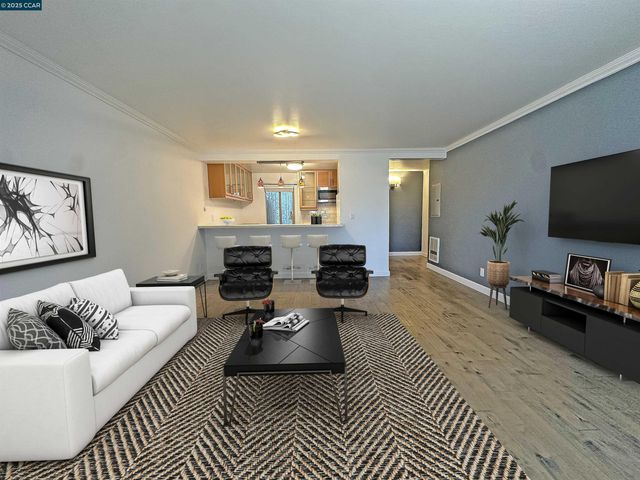 a kitchen with kitchen island granite countertop a stove a sink and dishwasher