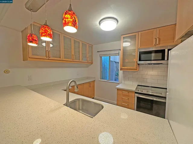 a kitchen that has a sink and a stove