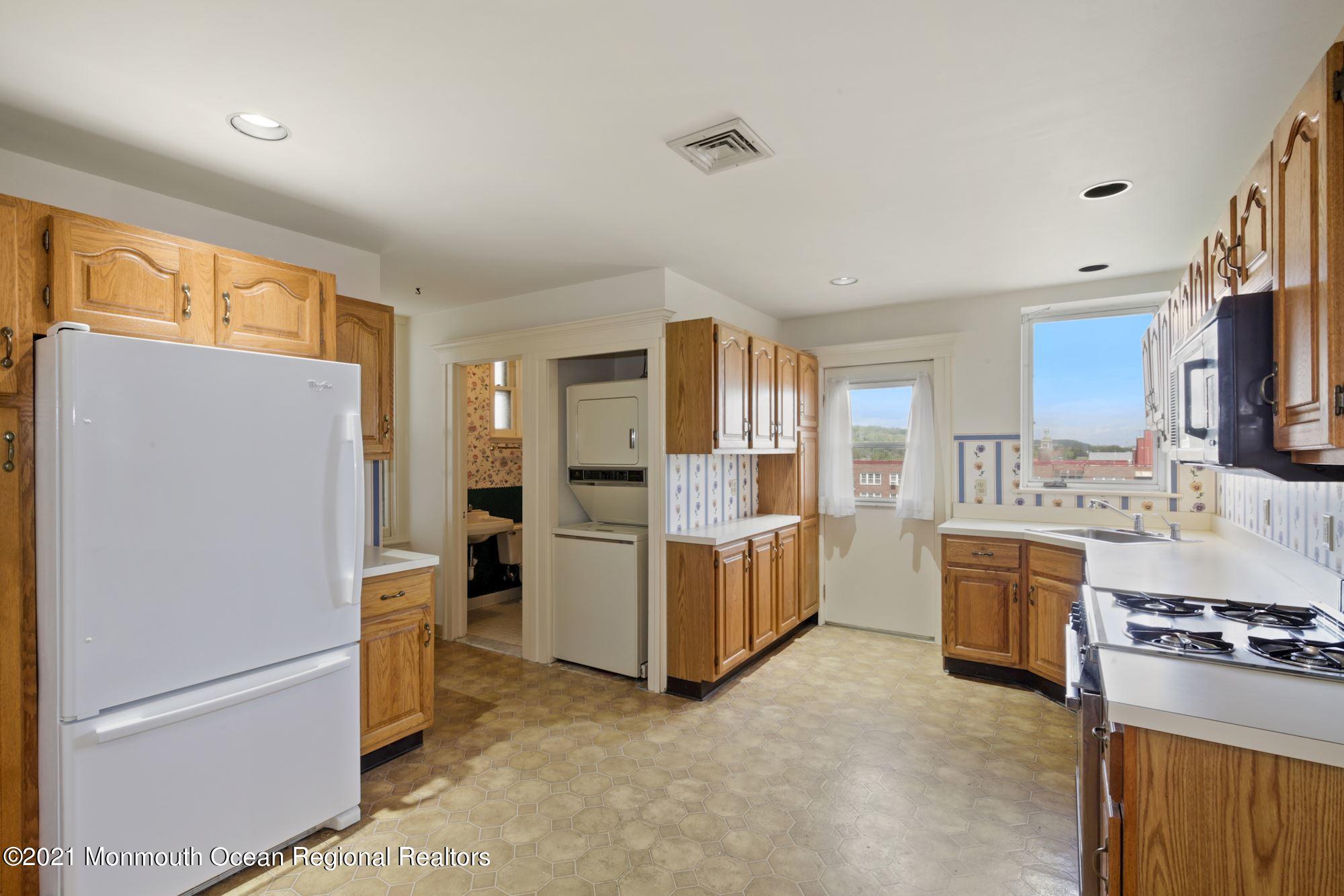 57 Union Street, Unit C4071 Montclair, NJ 07042 - Photo 18 of 27 a kitchen with white cabinets and stainless steel appliances