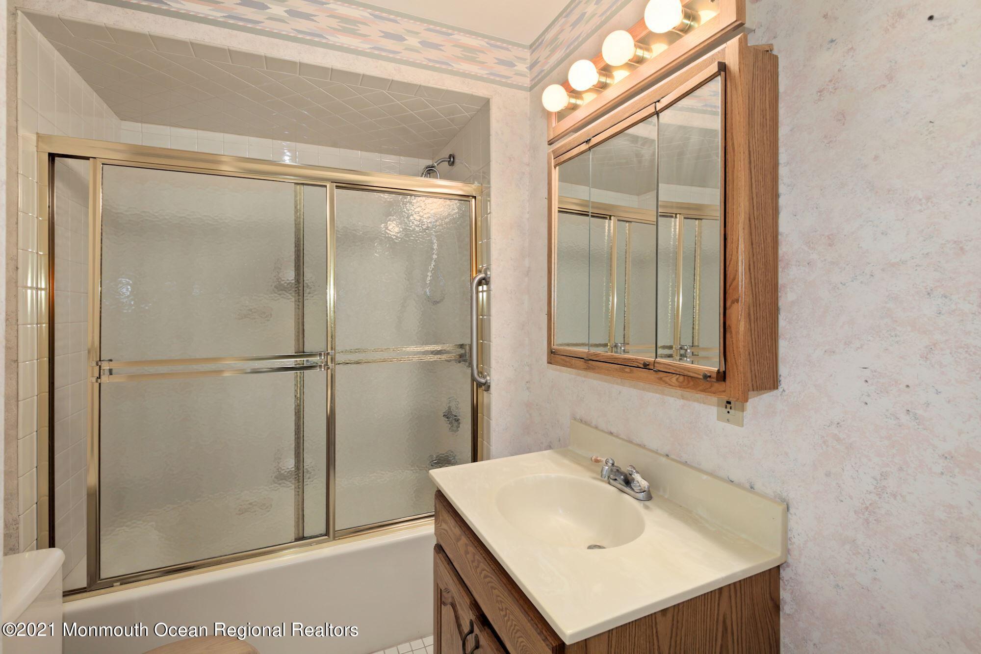 57 Union Street, Unit C4071 Montclair, NJ 07042 - Photo 23 of 27 a bathroom with a sink mirror and shower