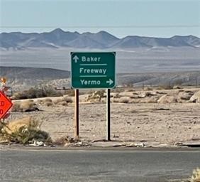 0 Th Baker, CA 92309 - Photo 12 of 17 a sign on the side of a road