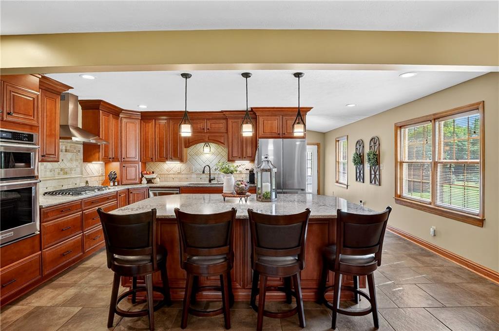 660 Allison Hollow Road Houston, PA 15342 - Photo 11 of 49 a dining area with stainless steel appliances kitchen island a table and chairs in it