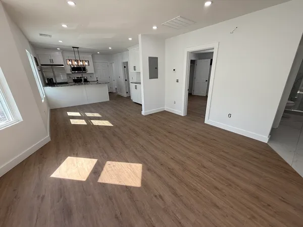 a view of entryway and hall with wooden floor