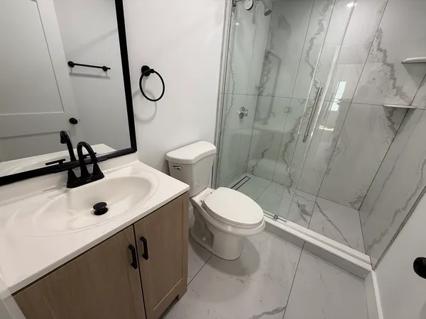 a bathroom with a sink toilet and shower