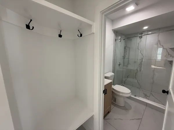 a bathroom with a toilet sink and shower