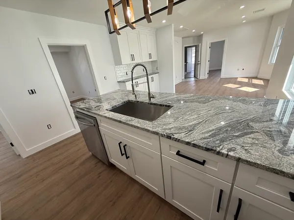 a kitchen with sink and mirror