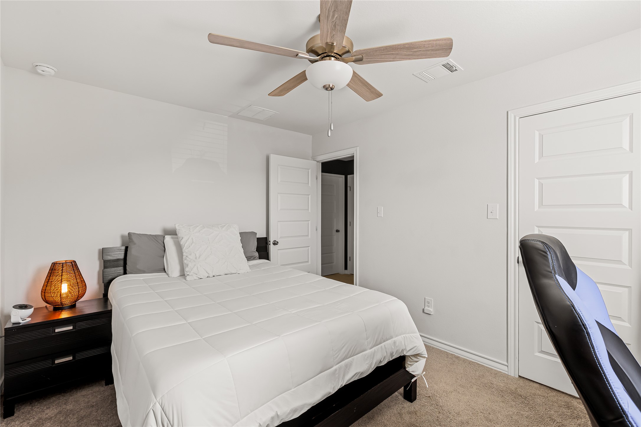862 Pepperbark Loop Buda, TX 78610 - Photo 28 of 40 a bedroom with a bed and a chandelier