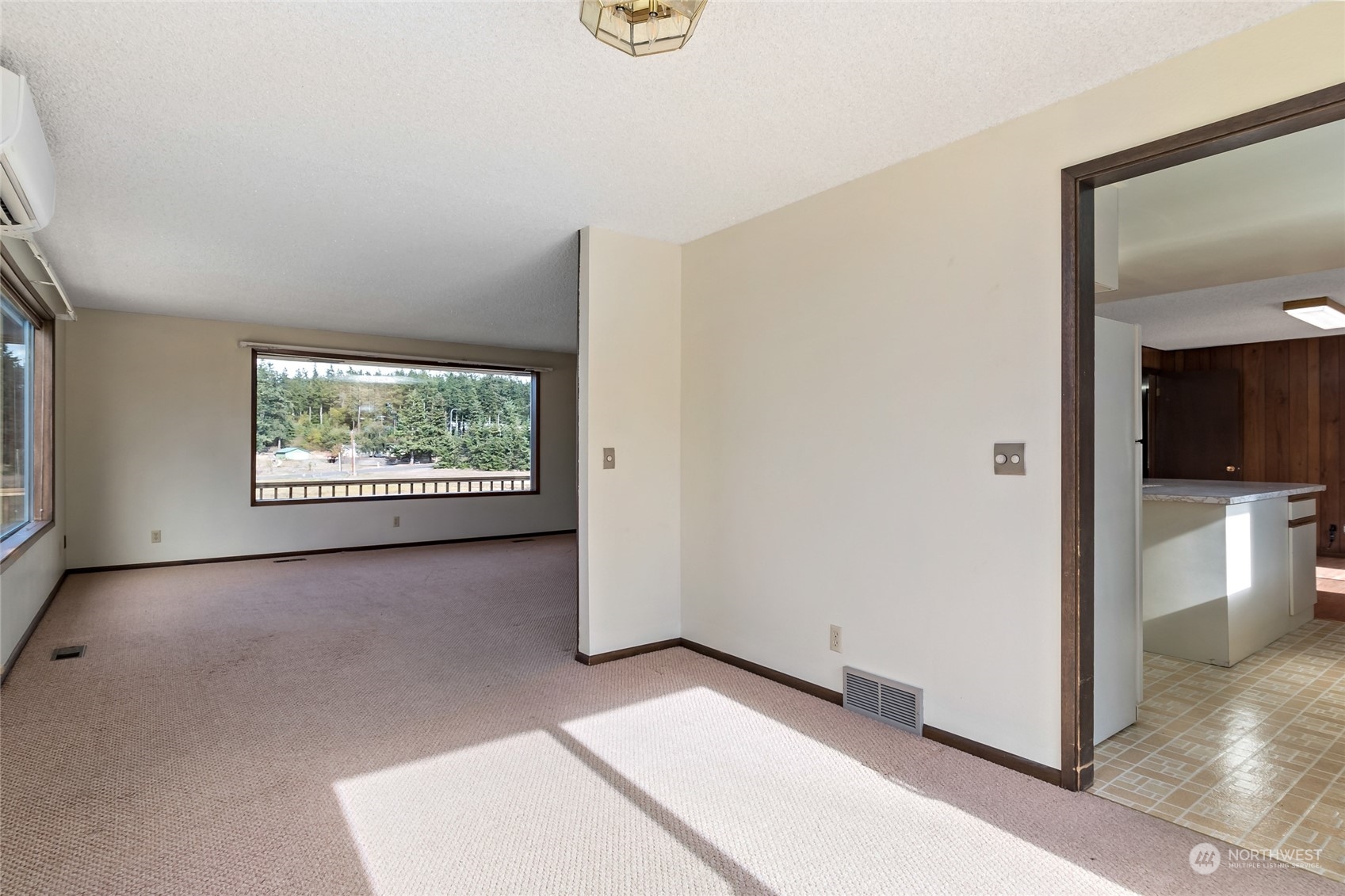 739 West Banta Road Oak Harbor, WA 98277 - Photo 21 of 40 a view of an empty room with wooden floor and a window