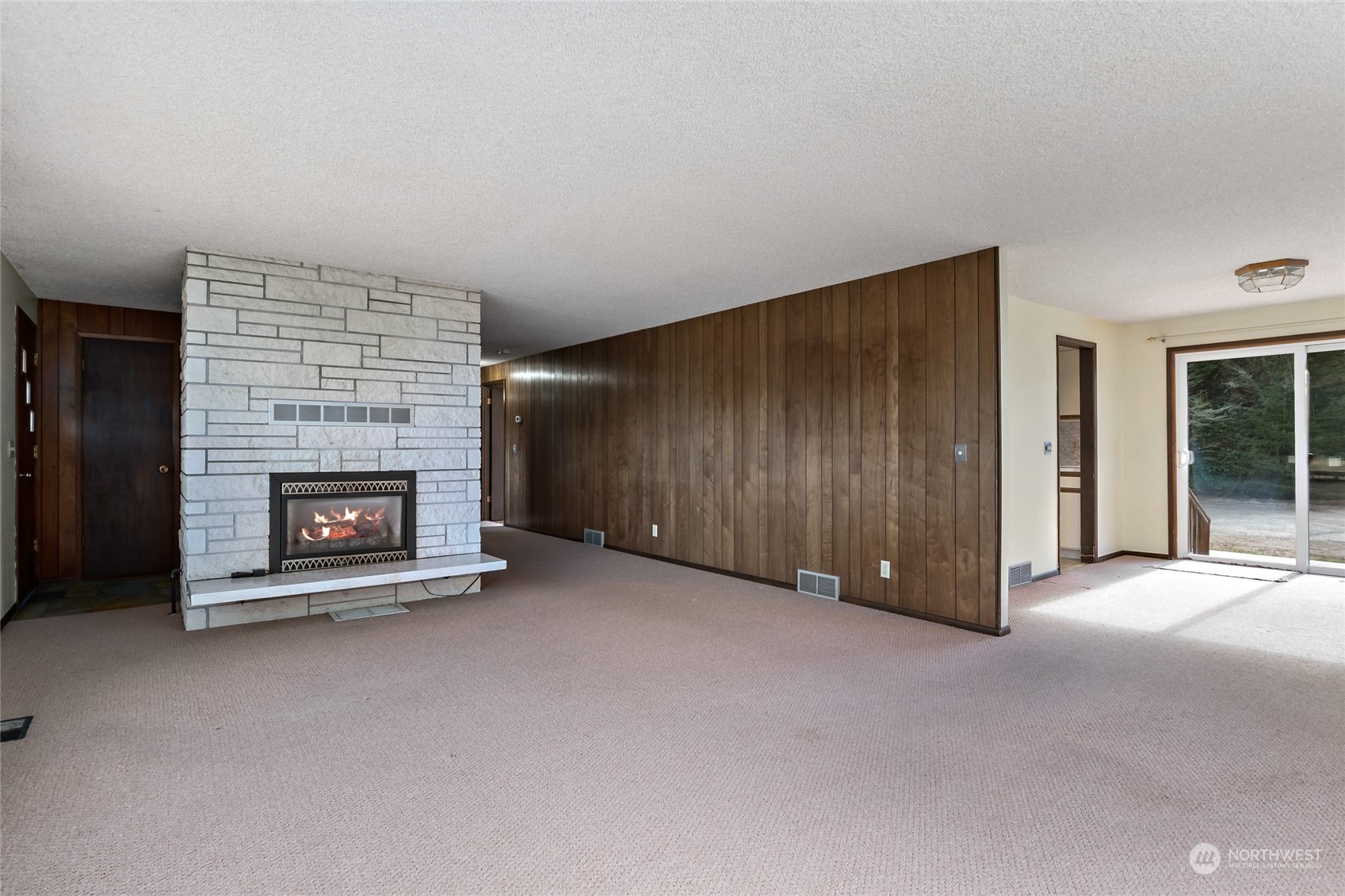 739 West Banta Road Oak Harbor, WA 98277 - Photo 26 of 40 a view of an empty room with a fireplace and a window