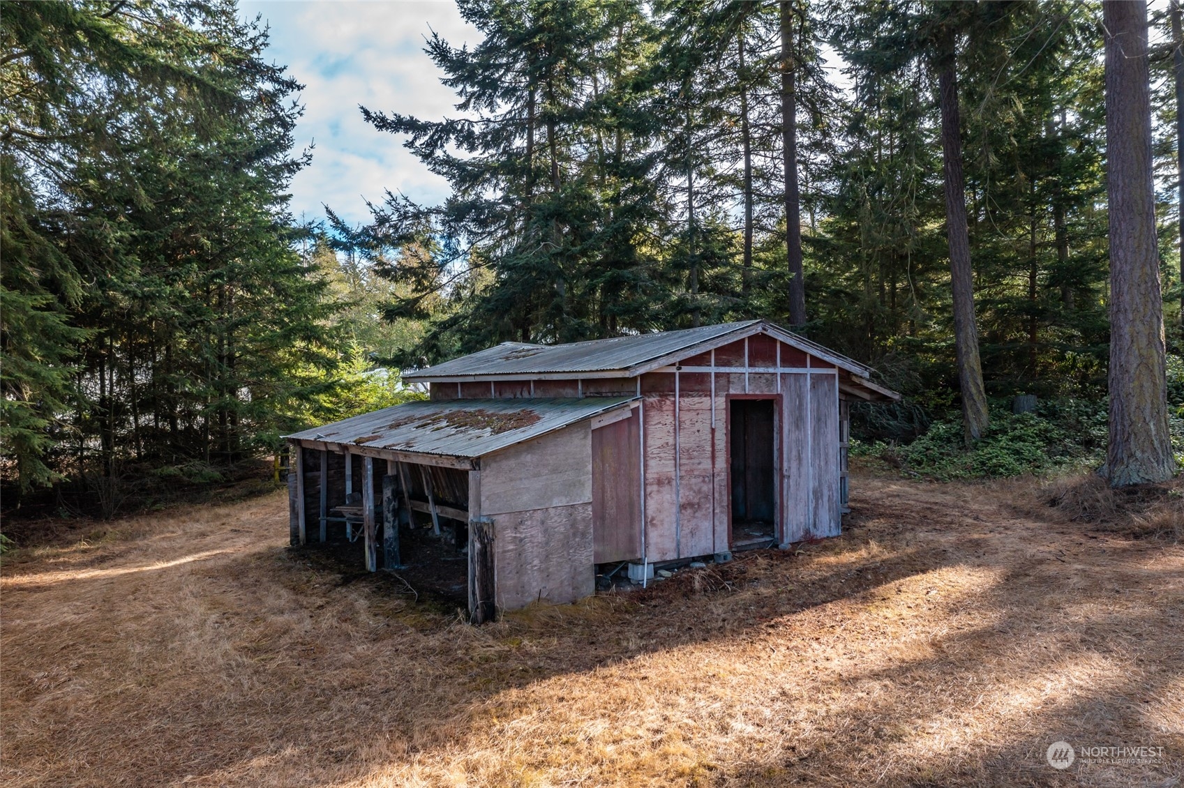 739 West Banta Road Oak Harbor, WA 98277 - Photo 37 of 40 a wooden house with large trees in the background