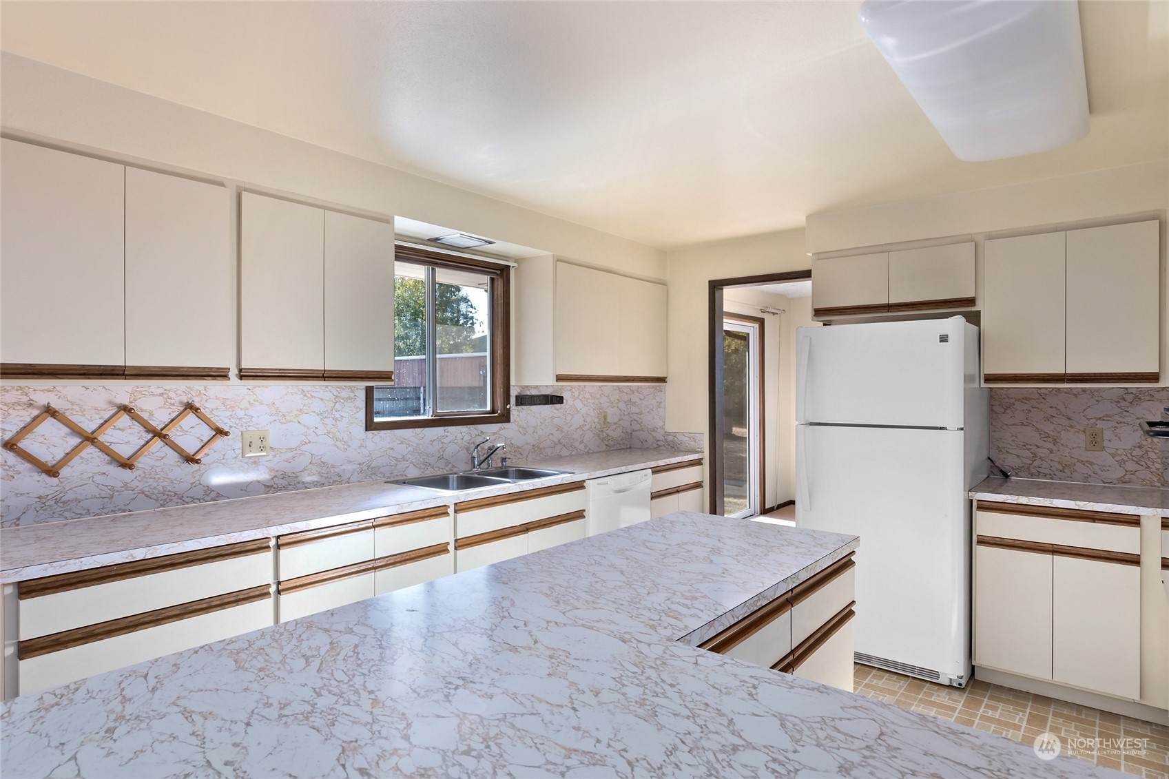 739 West Banta Road Oak Harbor, WA 98277 - Photo 6 of 40 a kitchen with white cabinets and refrigerator