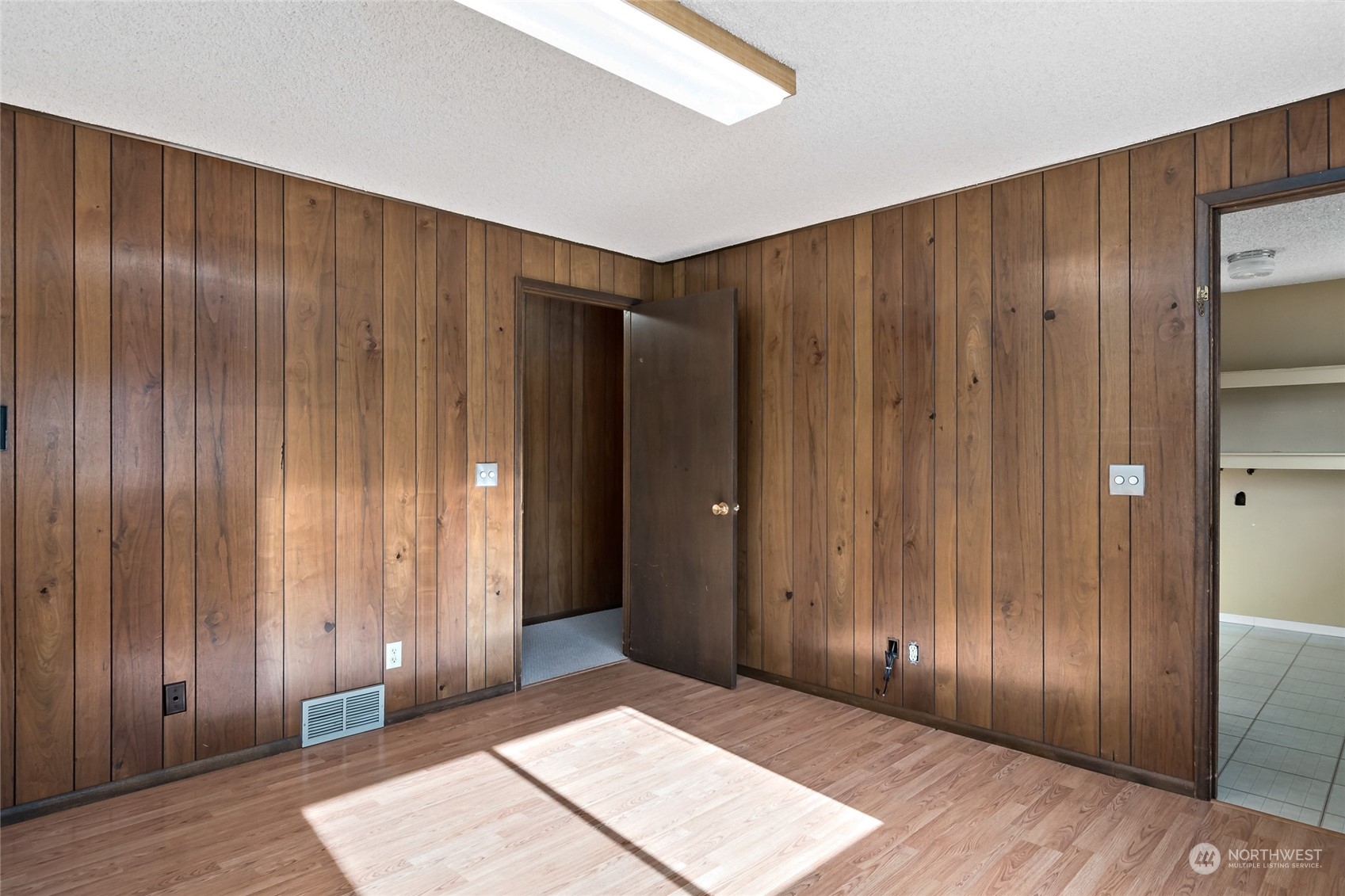 739 West Banta Road Oak Harbor, WA 98277 - Photo 9 of 40 a view of an empty room with wooden walls
