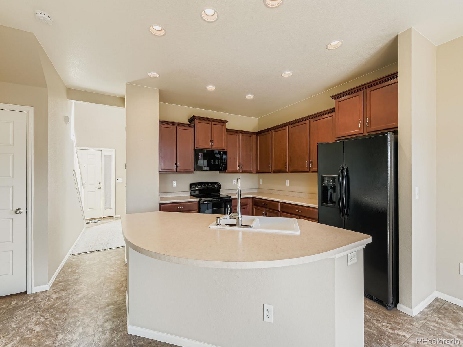8645 Raspberry Drive Frederick, CO 80504 - Photo 11 of 29 a kitchen with stainless steel appliances granite countertop a refrigerator a sink and a stove