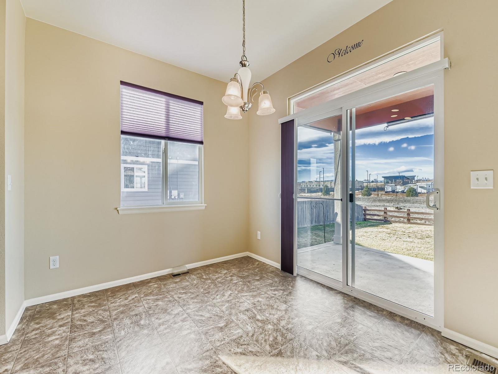 8645 Raspberry Drive Frederick, CO 80504 - Photo 16 of 29 a view of an empty room with window and chandelier