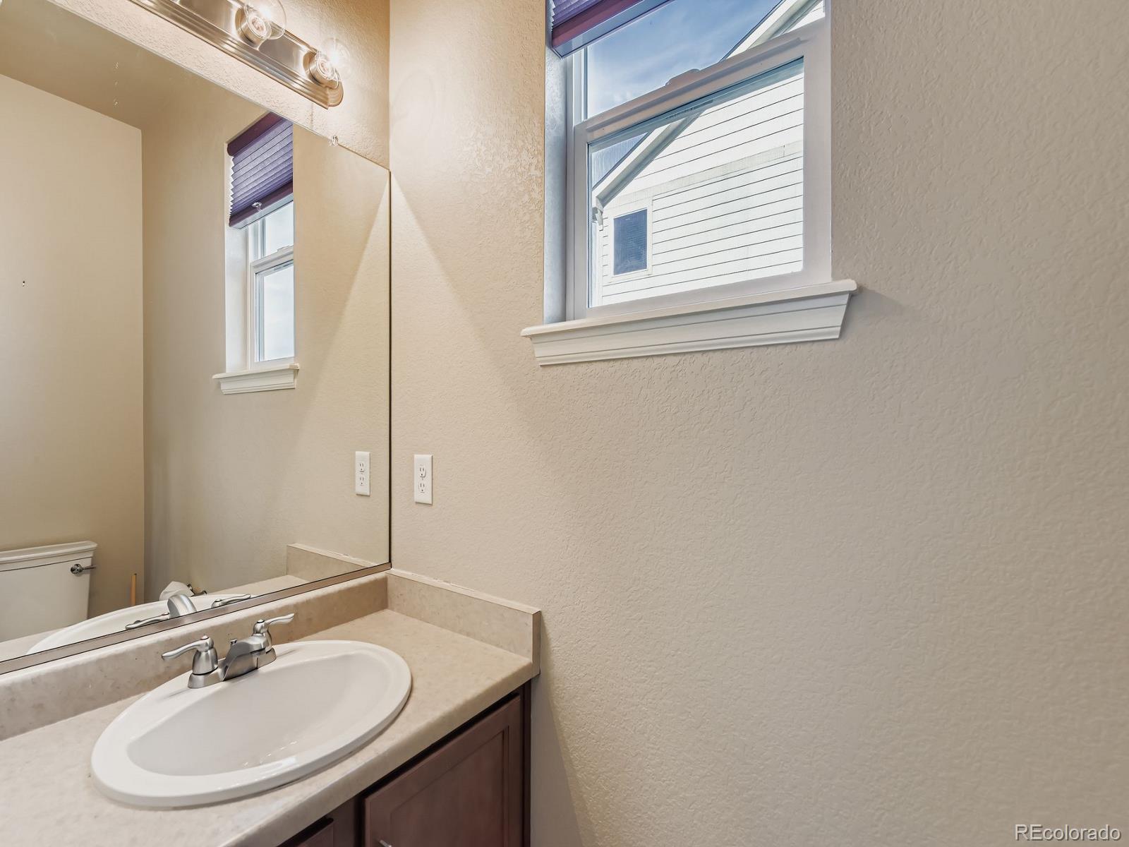 8645 Raspberry Drive Frederick, CO 80504 - Photo 17 of 29 a bathroom with a sink and a mirror