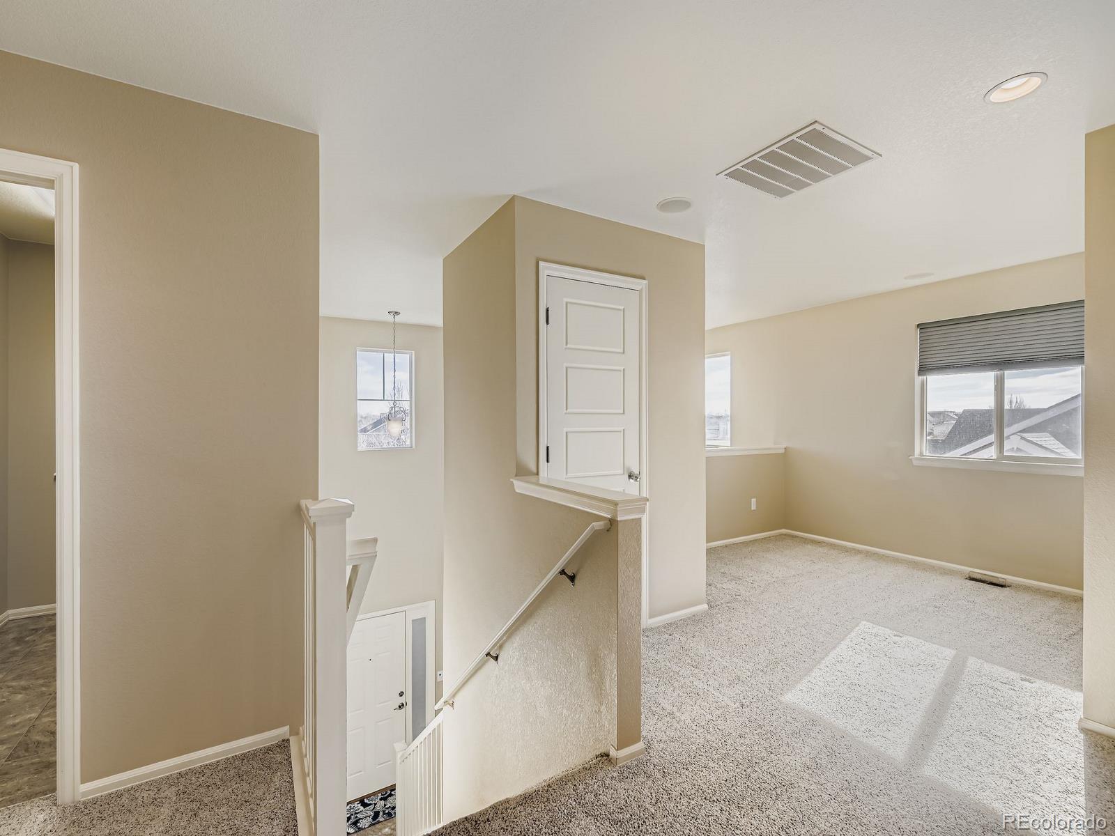 8645 Raspberry Drive Frederick, CO 80504 - Photo 20 of 29 a view of an empty room with window and stairs