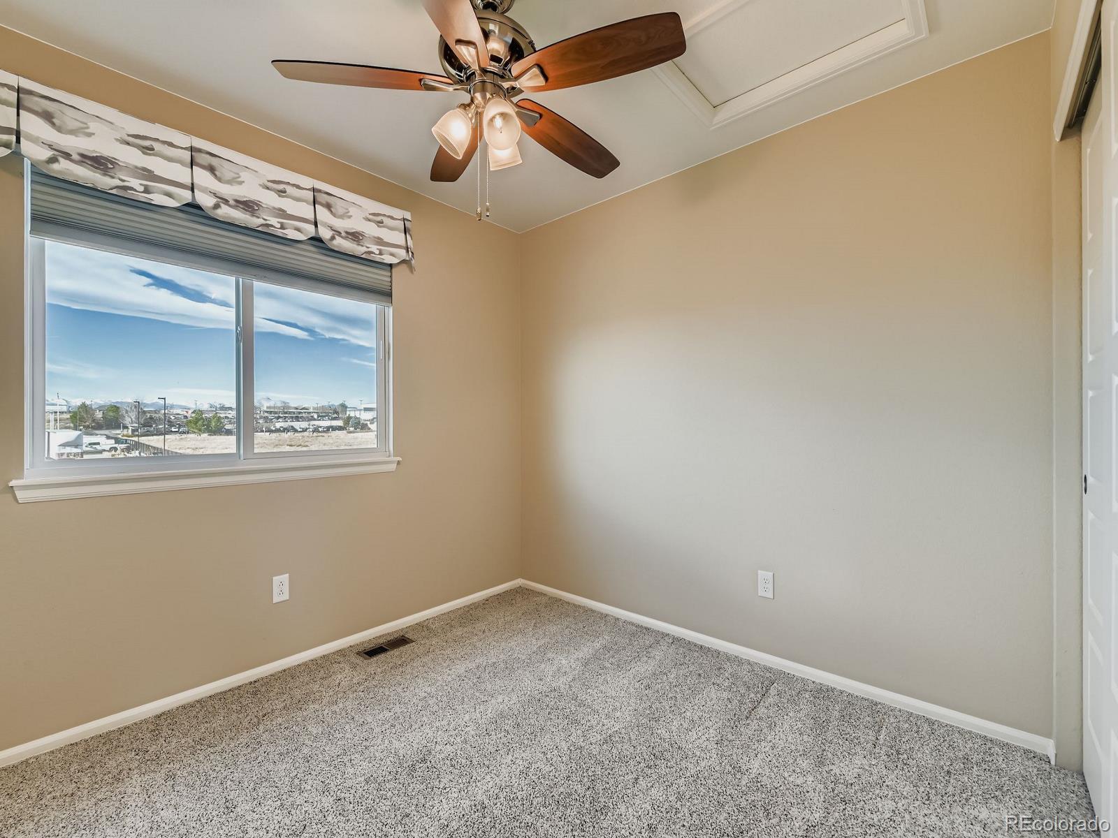 8645 Raspberry Drive Frederick, CO 80504 - Photo 26 of 29 an empty room with a window and a fan