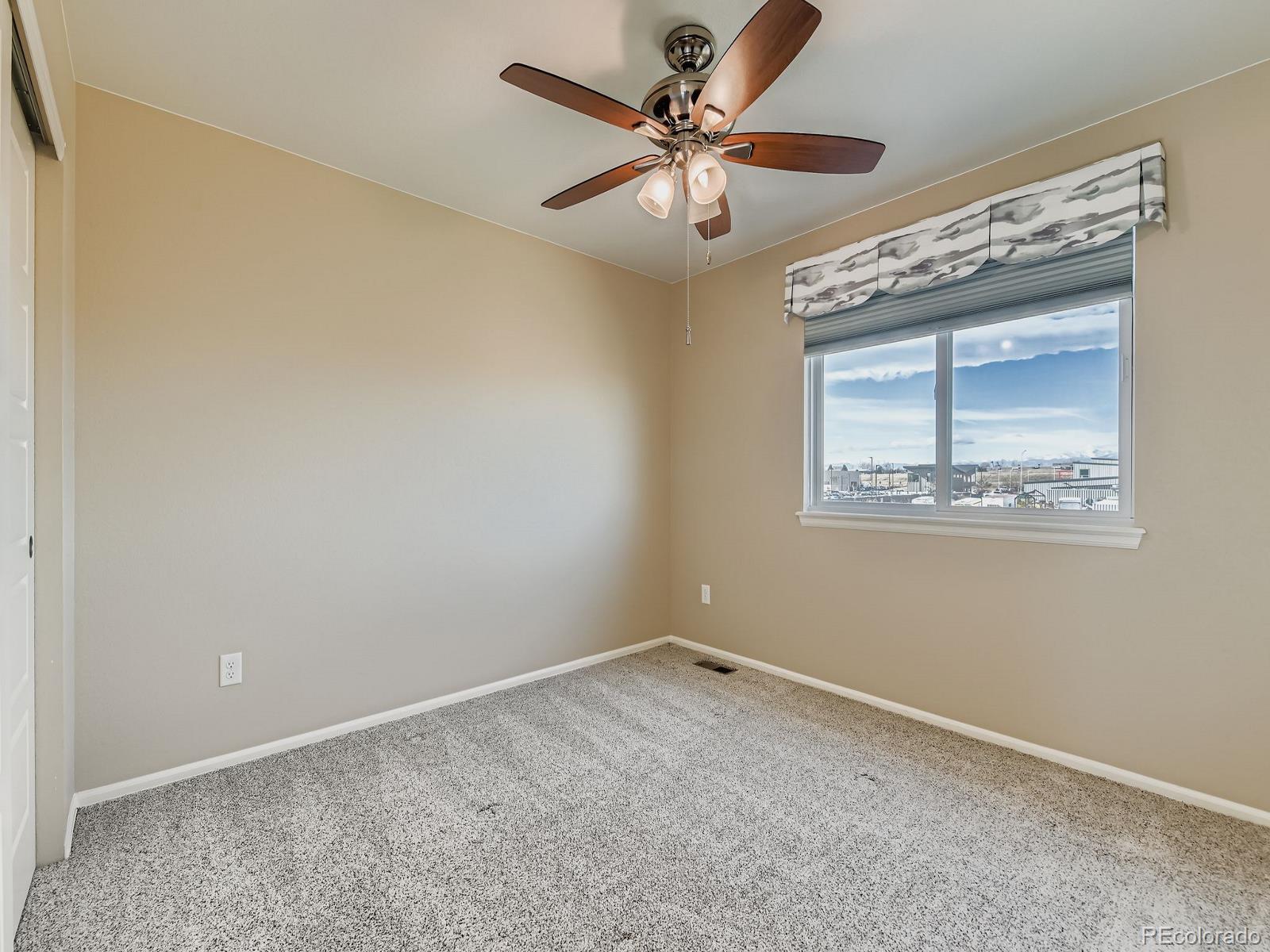 8645 Raspberry Drive Frederick, CO 80504 - Photo 27 of 29 an empty room with a window and a fan