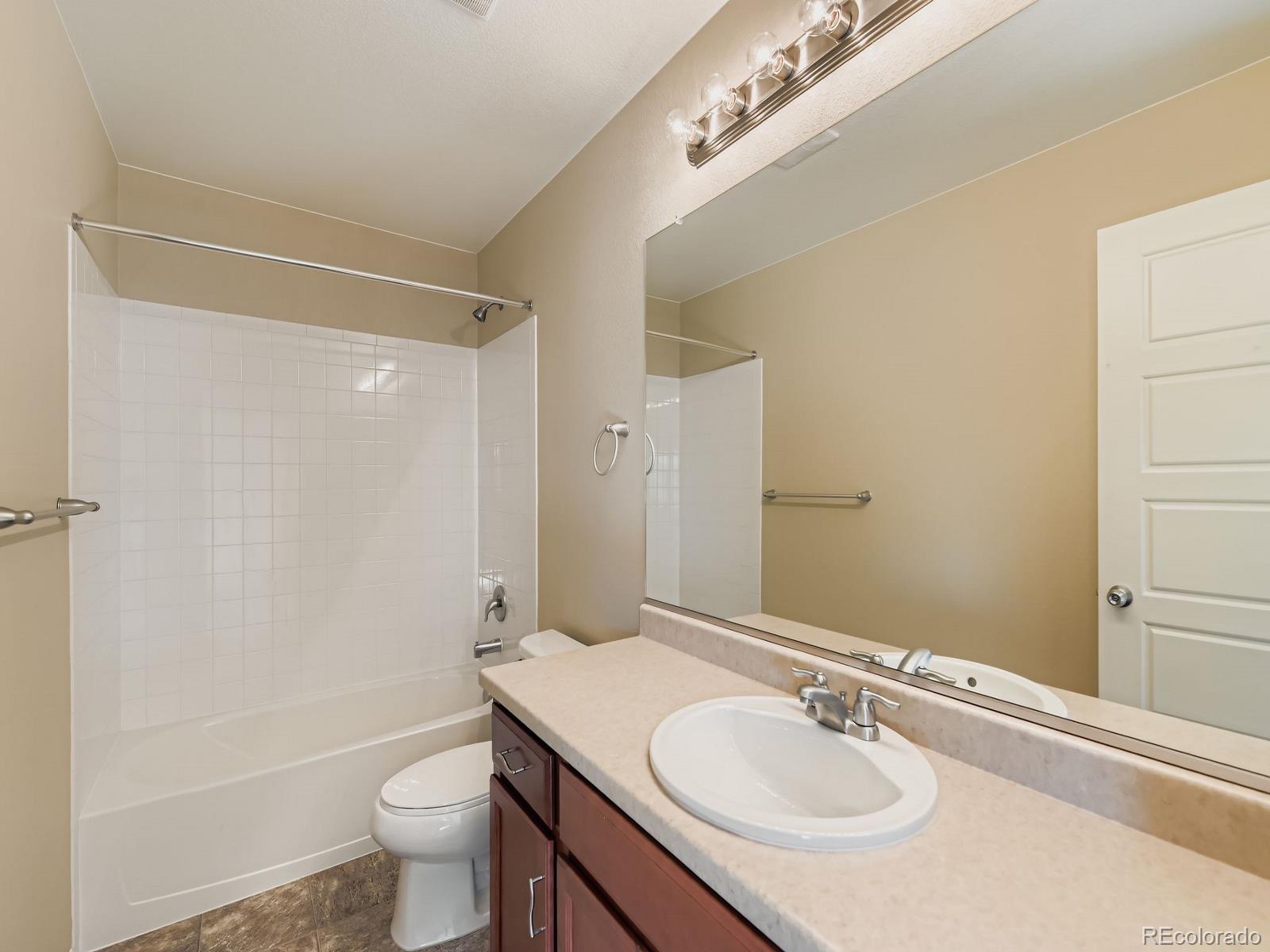 8645 Raspberry Drive Frederick, CO 80504 - Photo 28 of 29 a bathroom with a sink toilet and shower