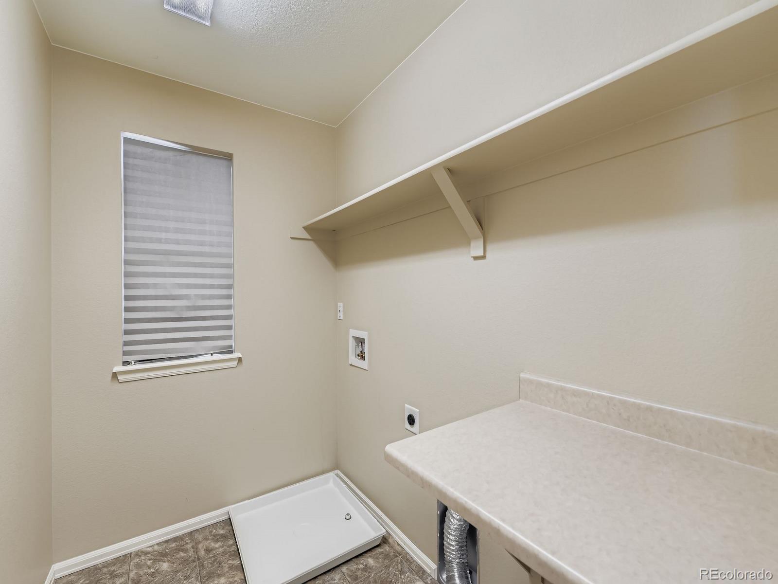 8645 Raspberry Drive Frederick, CO 80504 - Photo 29 of 29 a room with a window and wooden floor