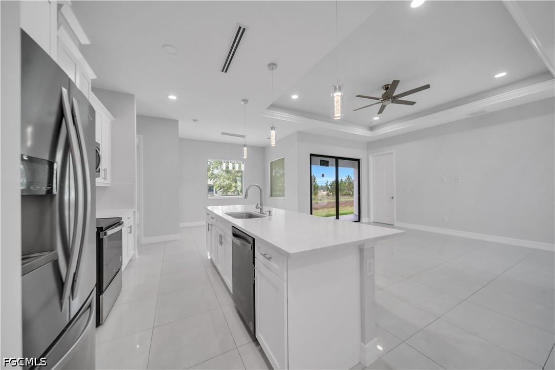 3509 38th Street Southwest Lehigh Acres, FL 33976 - Photo 13 of 47 a kitchen with stainless steel appliances a sink stove and refrigerator