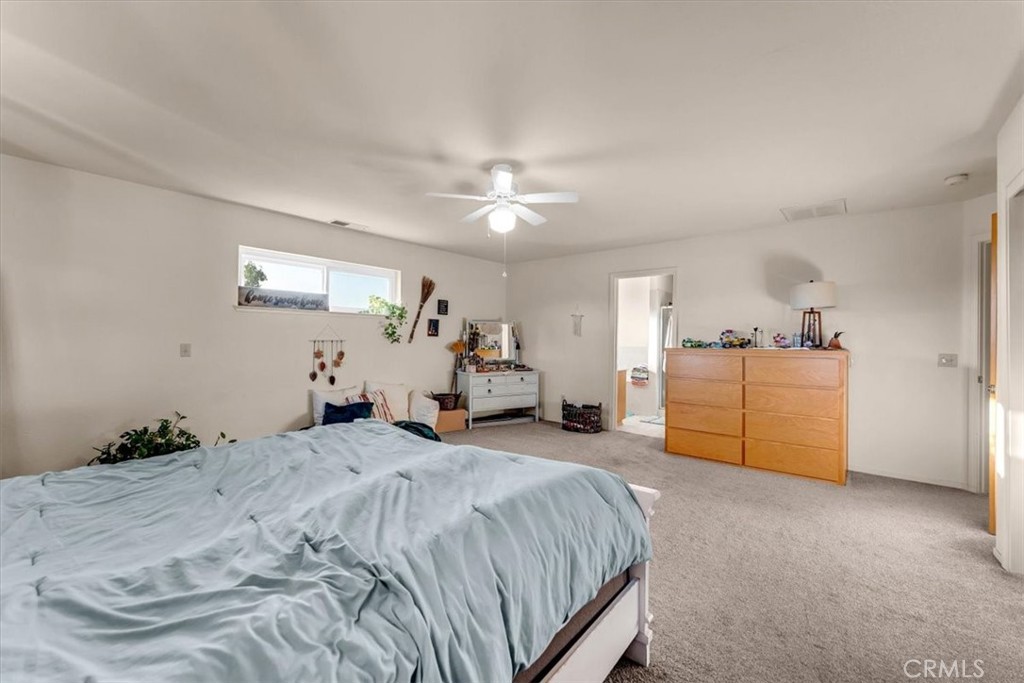 21550 Leaf Avenue Corning, CA 96021 - Photo 15 of 71 a spacious bedroom with a bed and a cabinets