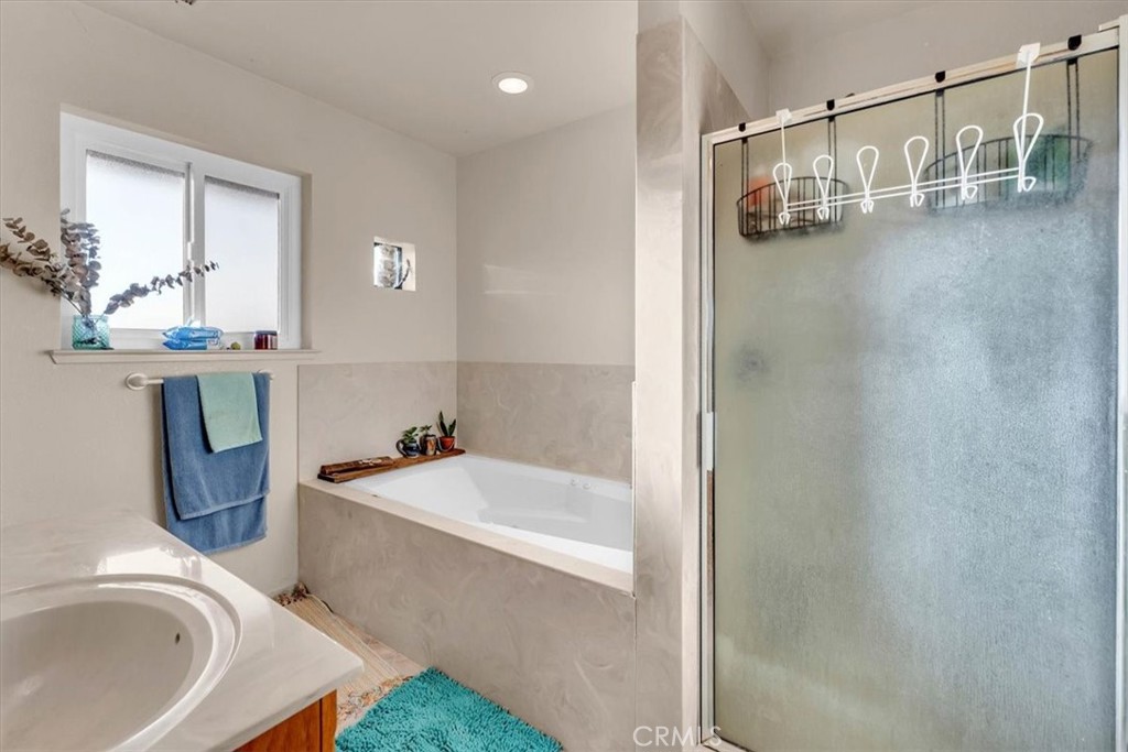 21550 Leaf Avenue Corning, CA 96021 - Photo 17 of 71 a bathroom with a tub a sink and a mirror
