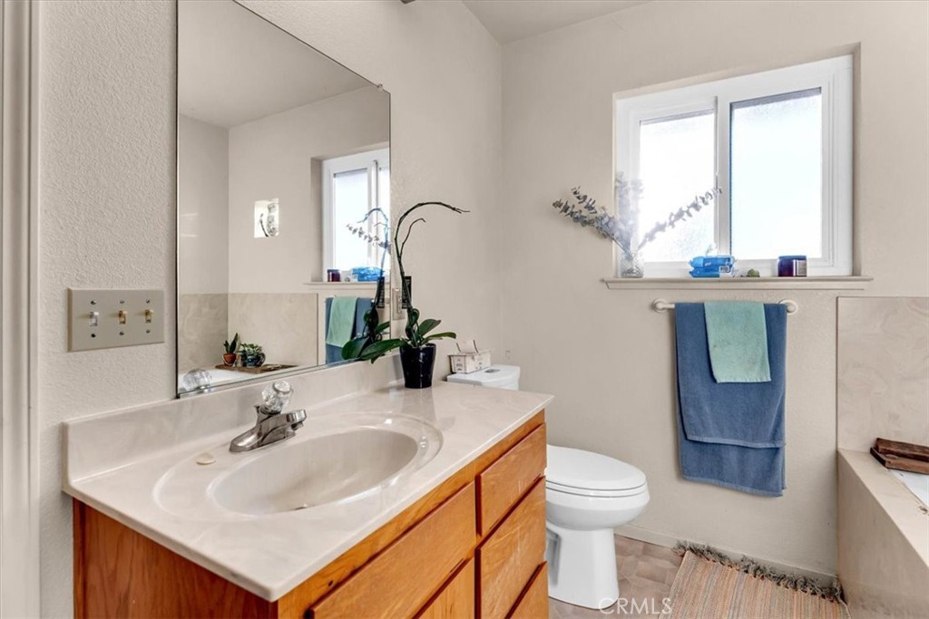 21550 Leaf Avenue Corning, CA 96021 - Photo 19 of 71 a bathroom with a toilet sink and mirror