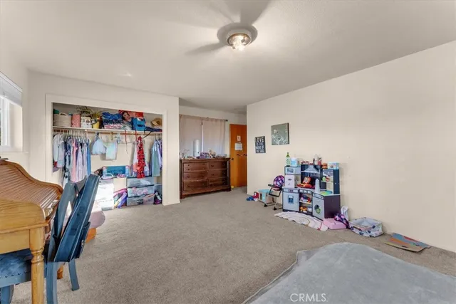 a bathroom with a granite countertop sink a toilet and a mirror