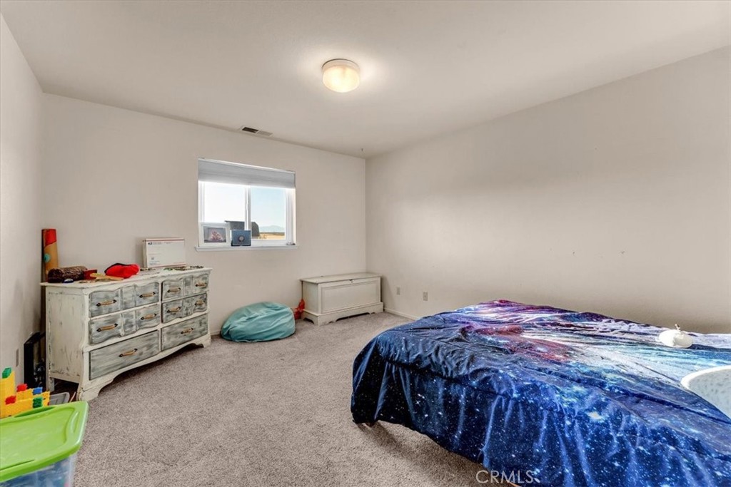 21550 Leaf Avenue Corning, CA 96021 - Photo 23 of 71 a bedroom with a bed and a dresser