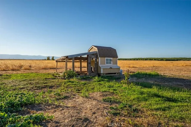 a view of a house with yard and sitting area