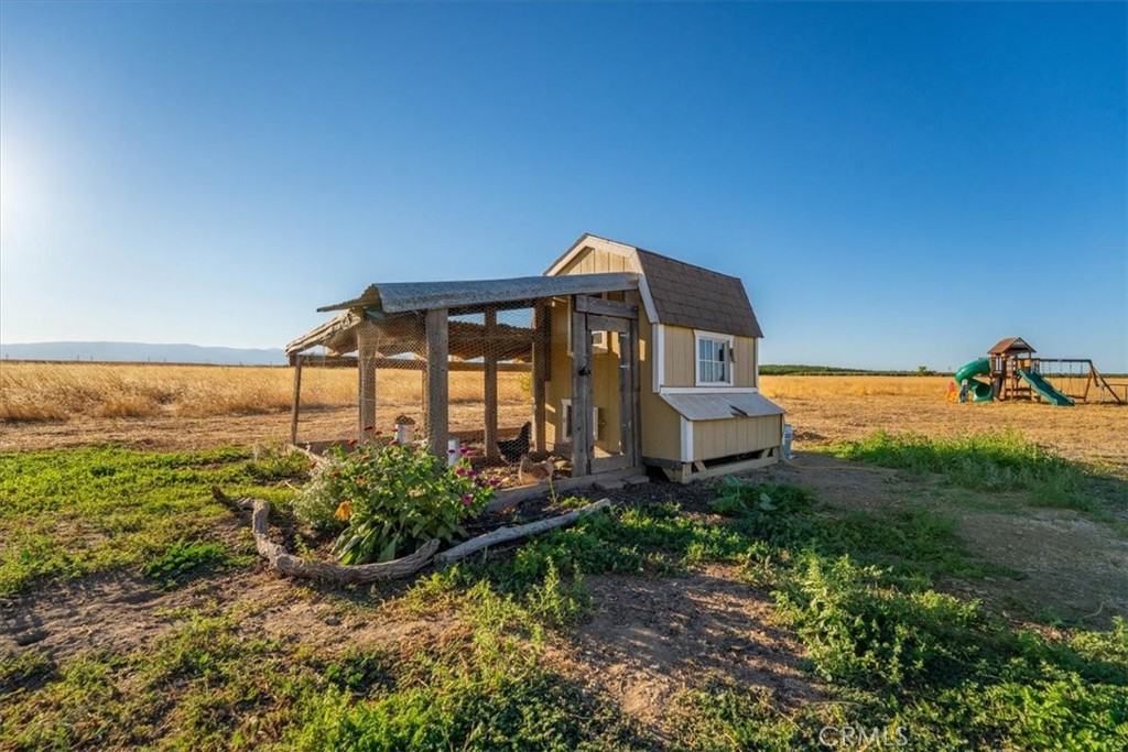 21550 Leaf Avenue Corning, CA 96021 - Photo 47 of 71 a front view of a house with a garden