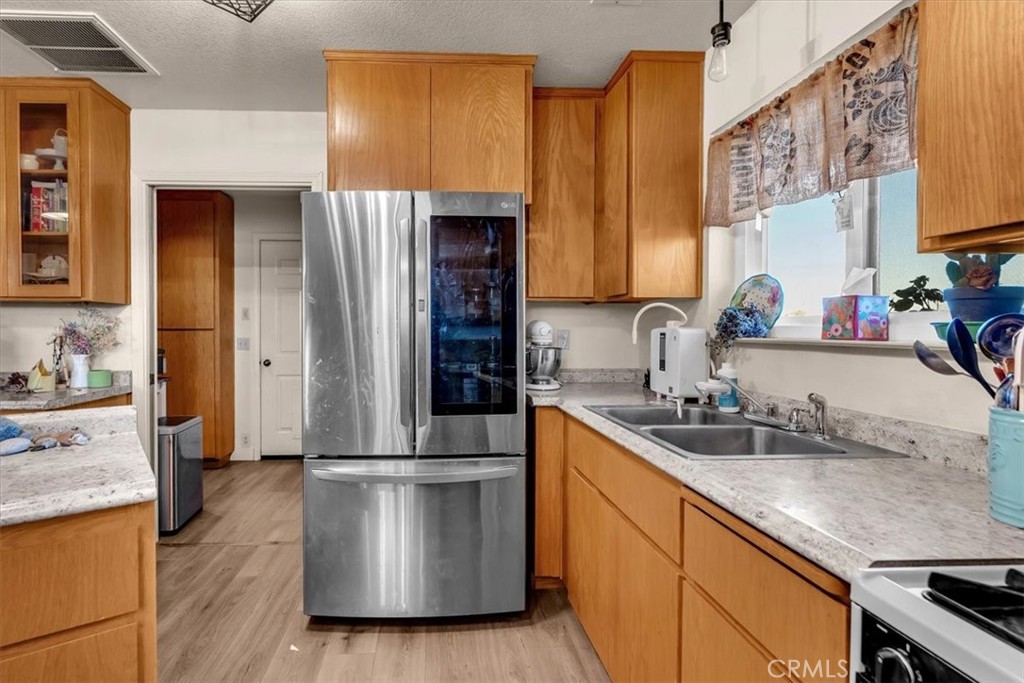 21550 Leaf Avenue Corning, CA 96021 - Photo 10 of 71 a kitchen with stainless steel appliances granite countertop a sink stove and refrigerator