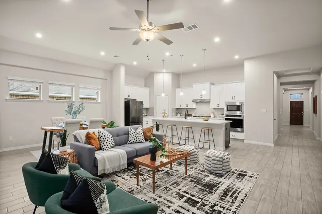 a living room with furniture and kitchen view