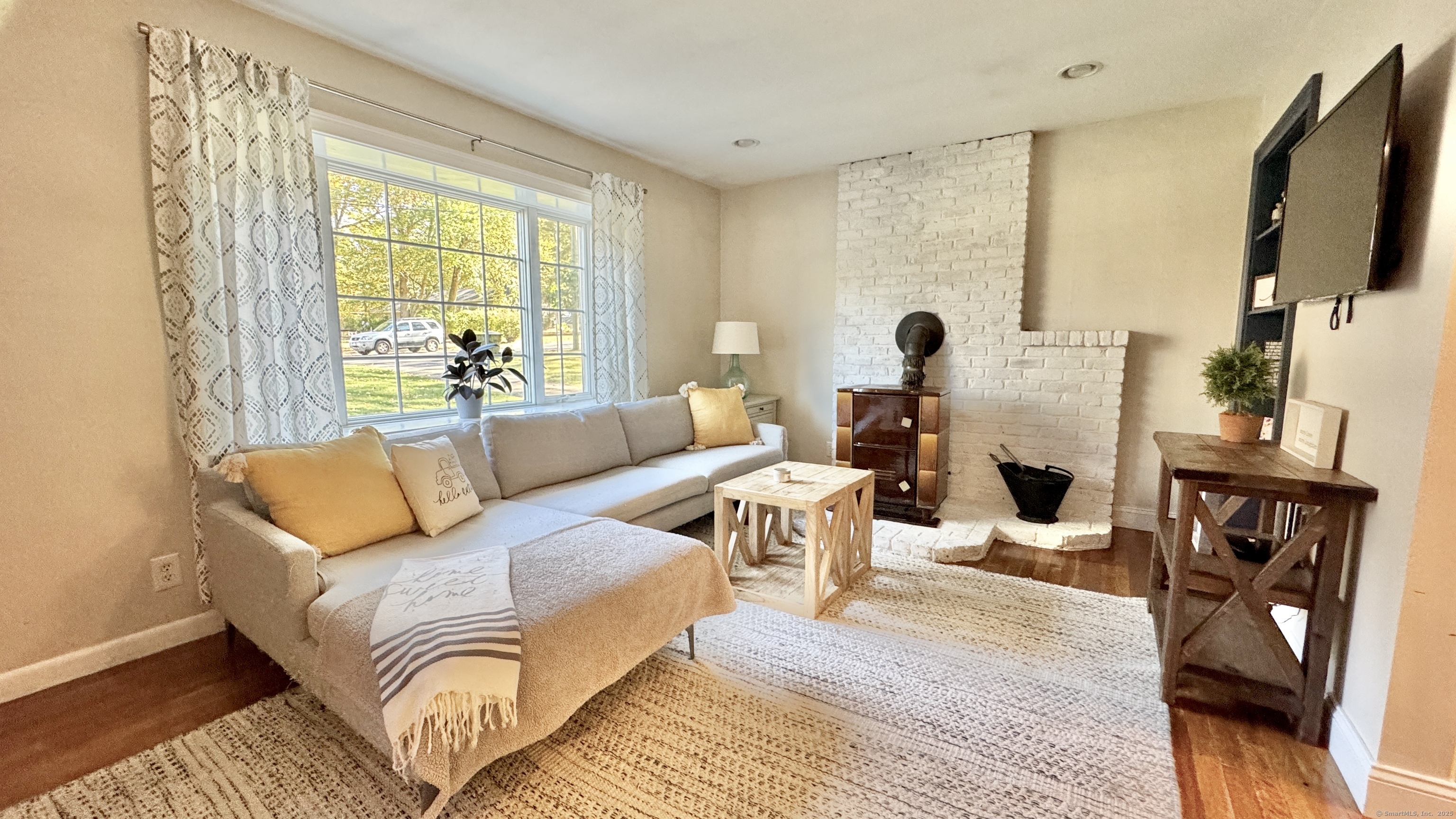 a living room with furniture and a flat screen tv