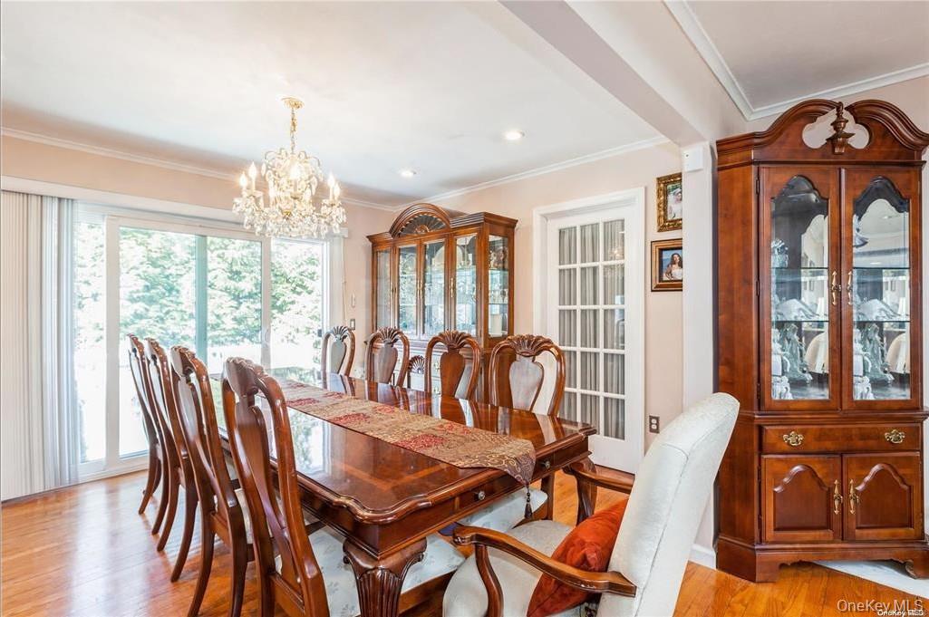 77 Duck Pond Road Glen Cove, NY 11542 - Photo 20 of 36 a view of a dining room with furniture wooden floor and chandelier