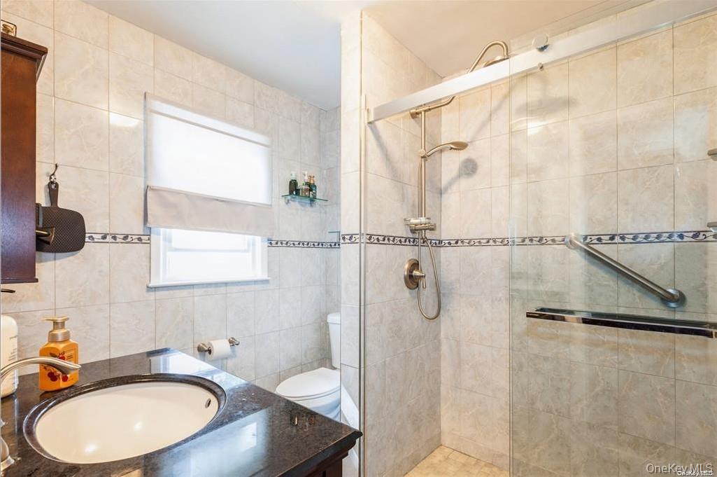 77 Duck Pond Road Glen Cove, NY 11542 - Photo 23 of 36 a bathroom with a sink toilet and shower