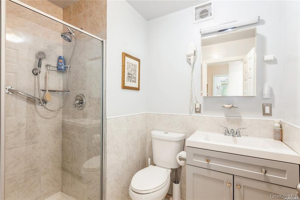 77 Duck Pond Road Glen Cove, NY 11542 - Photo 25 of 36 a bathroom with a sink a toilet and shower
