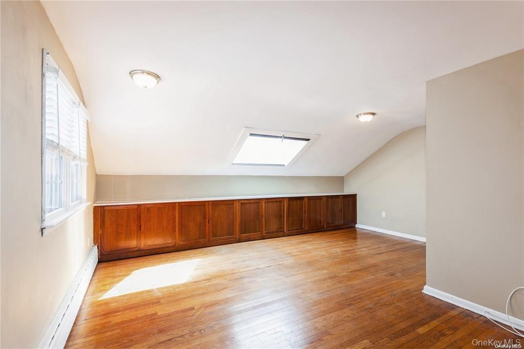 77 Duck Pond Road Glen Cove, NY 11542 - Photo 28 of 36 a view of an empty room with wooden floor and a window