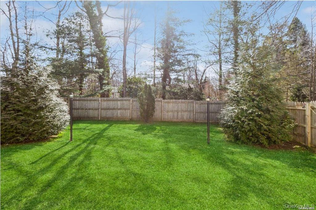 77 Duck Pond Road Glen Cove, NY 11542 - Photo 30 of 36 a view of a backyard with large trees