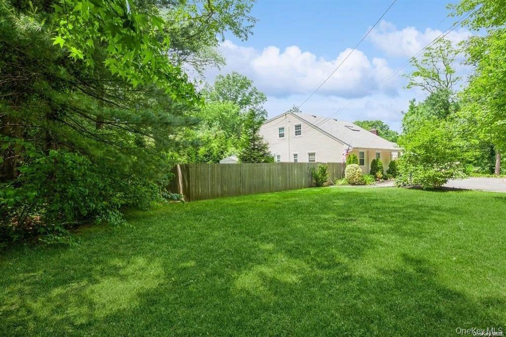 77 Duck Pond Road Glen Cove, NY 11542 - Photo 31 of 36 a view of house with backyard and garden