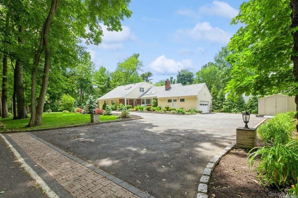 77 Duck Pond Road Glen Cove, NY 11542 - Photo 5 of 36 a view of a park with a bench and trees