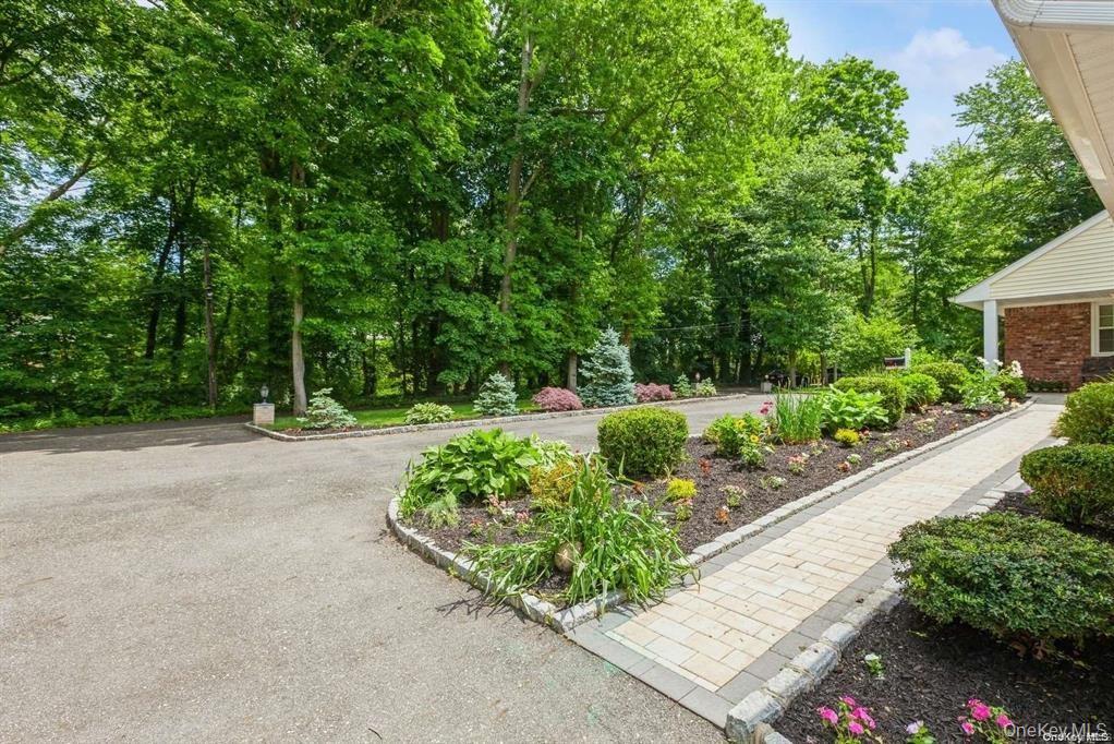 77 Duck Pond Road Glen Cove, NY 11542 - Photo 8 of 36 a view of a garden with a pathway