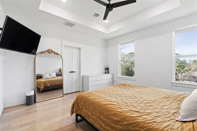 a bedroom with a bed and a flat screen tv