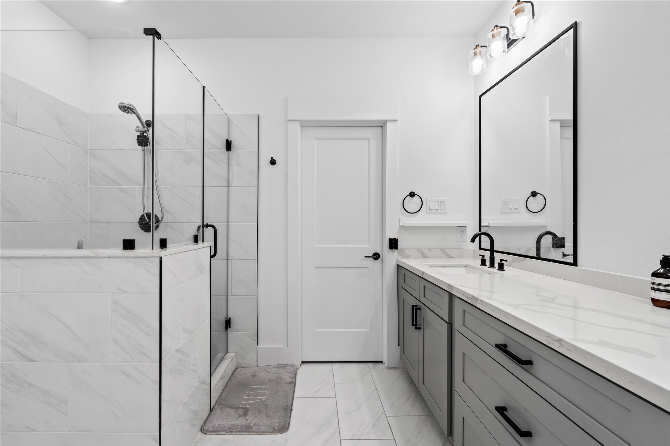 1835 Flowing Springs Trail Houston, TX 77080 - Photo 21 of 25 a spacious bathroom with a granite countertop sink a mirror and shower