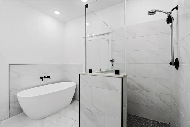 a bathroom with a bathtub and shower